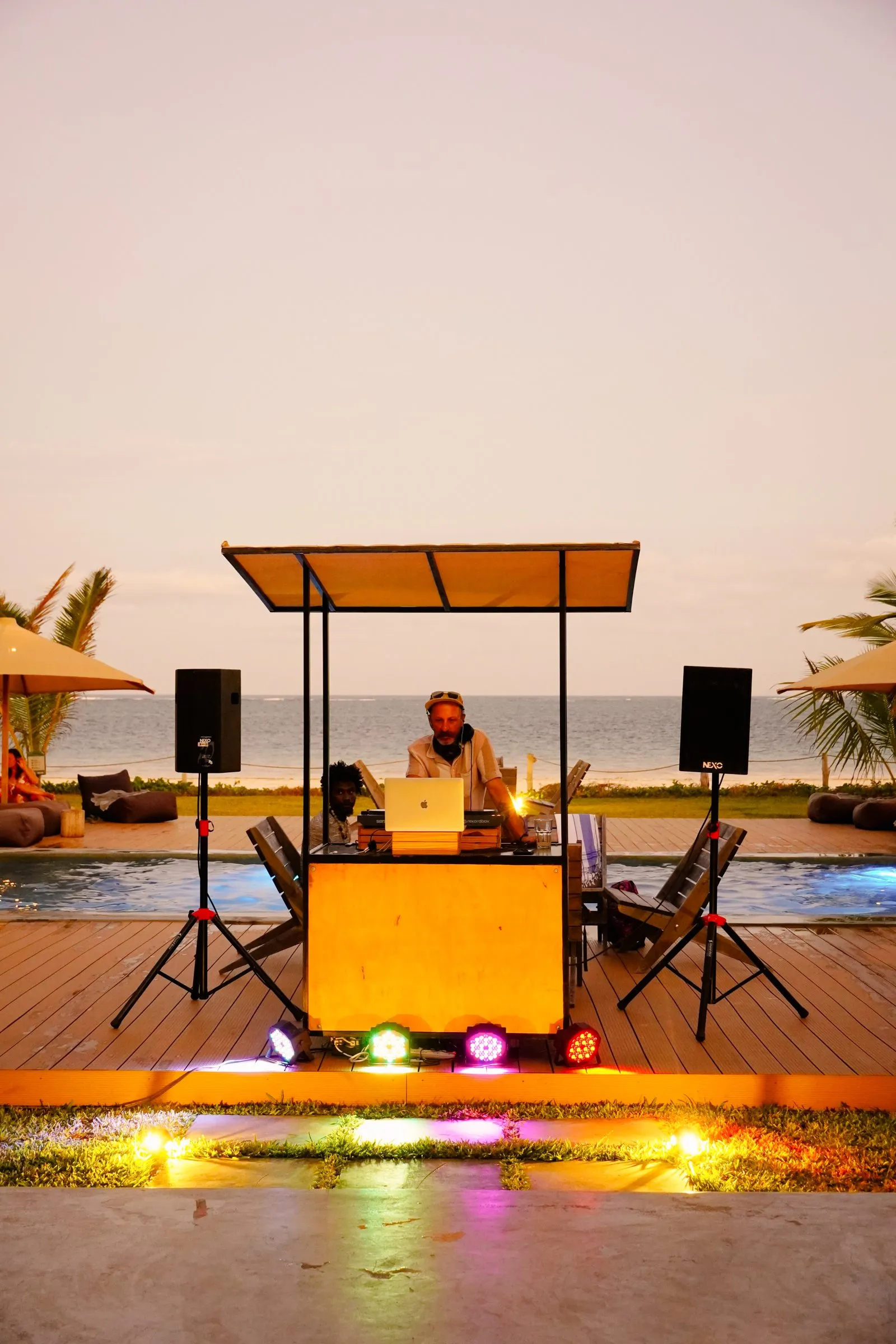 DJ booth by the pool at dusk