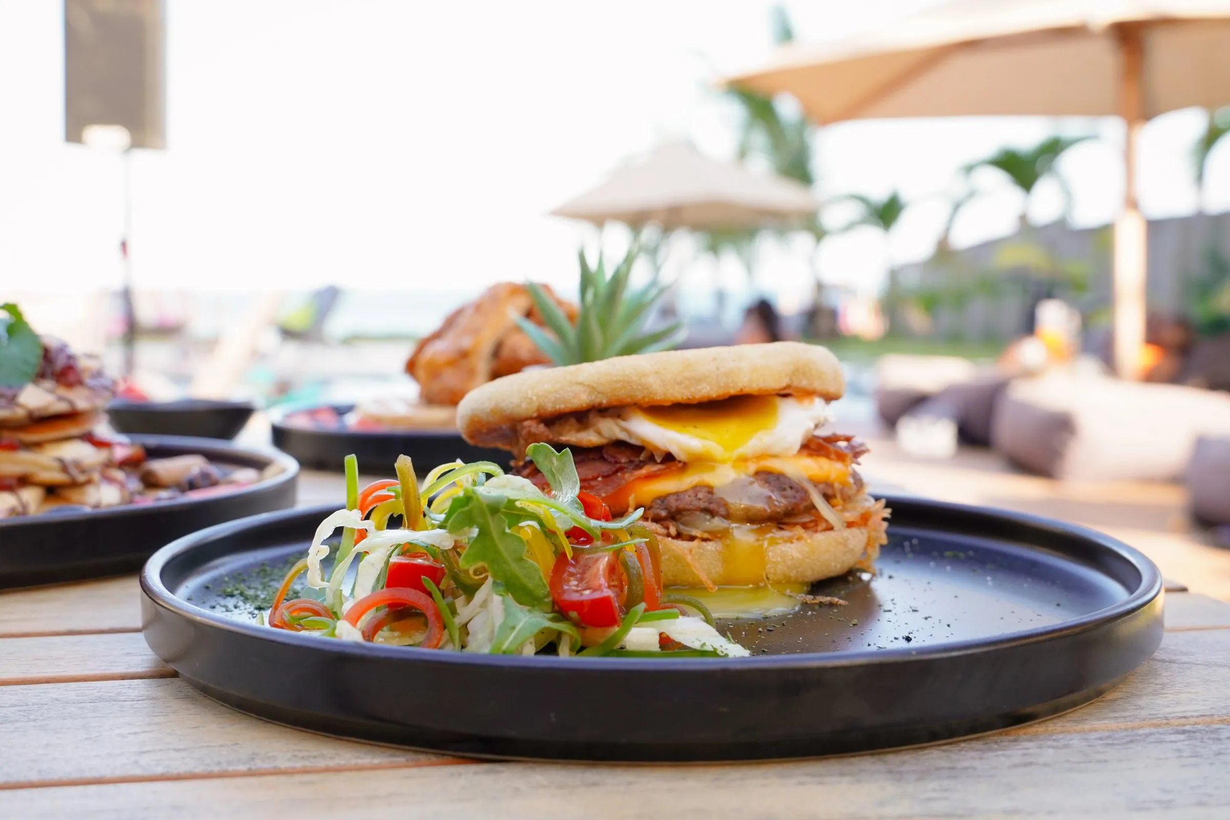 Breakfast burger at Sunnyside Up with the pool behind