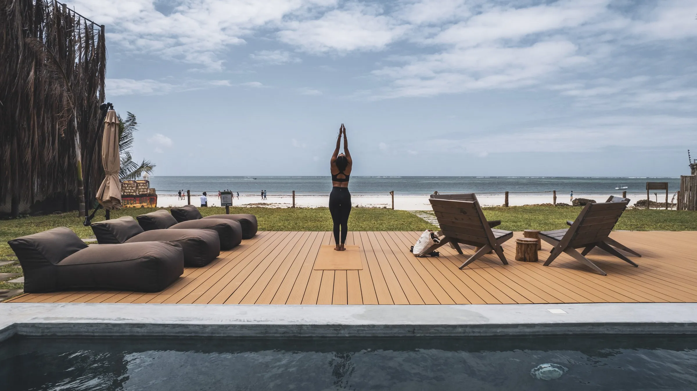 Morning yoga on the deck above the pool, sea beyond