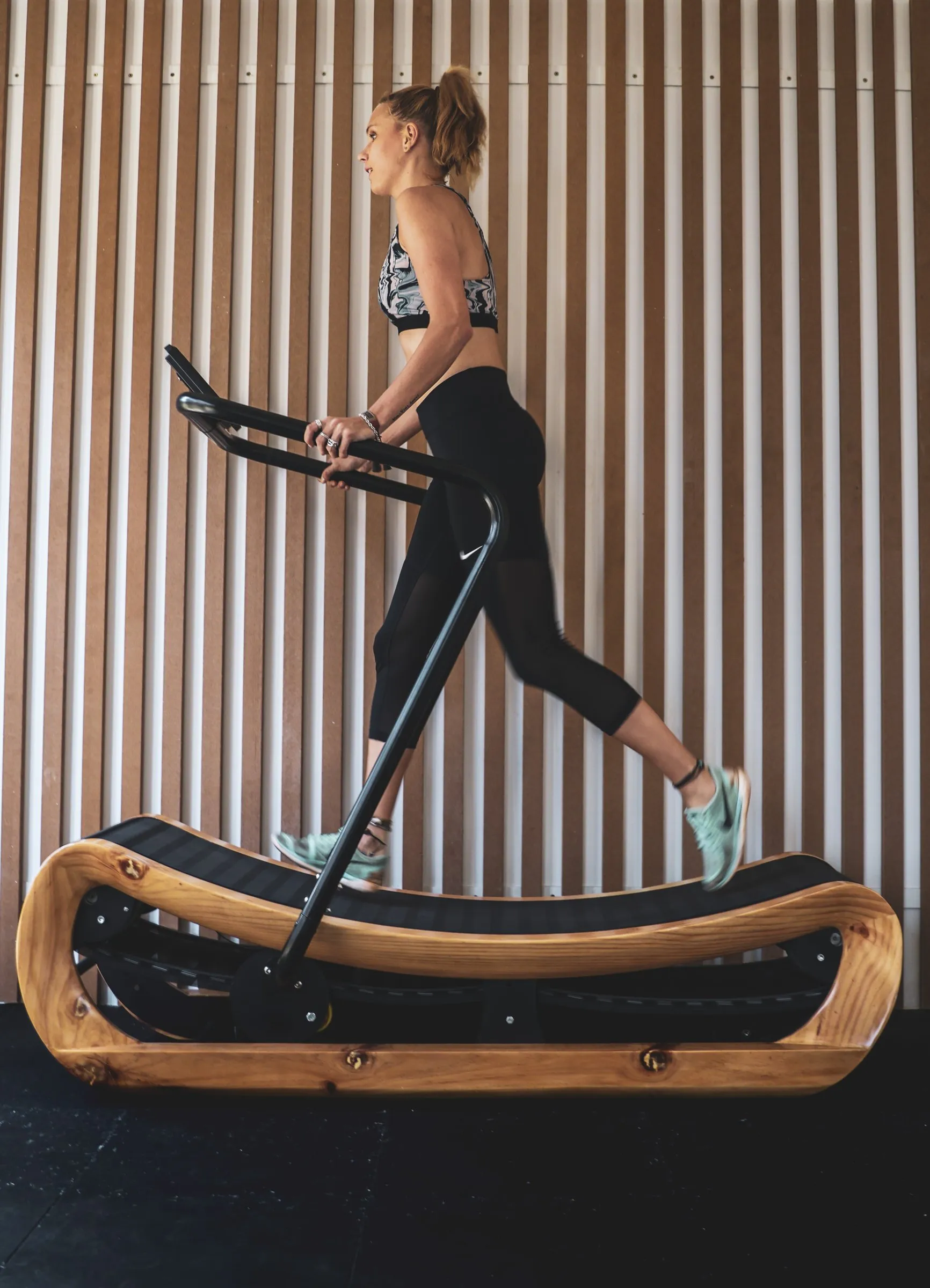 The curved wooden treadmill in the gym